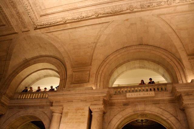 A crowd watches The Walkmen play the lobby of the NYPL